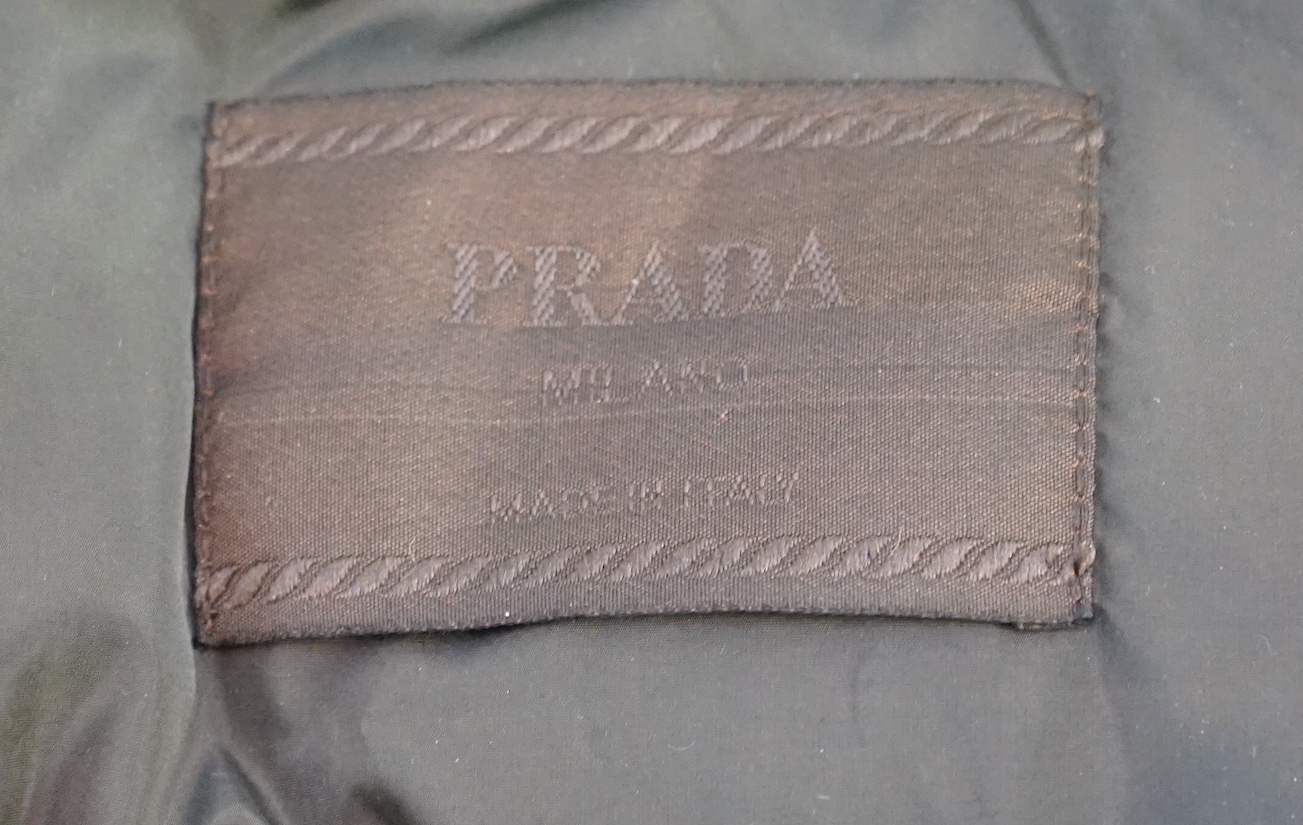 A Prada quilted olive green and brown lady's gilet with hood in collar, size M